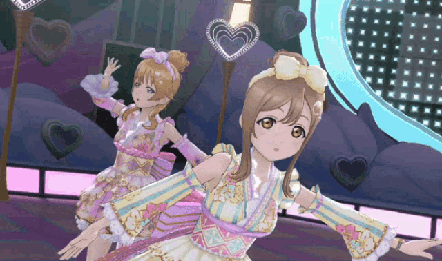 two anime girls are dancing on a stage in front of hearts