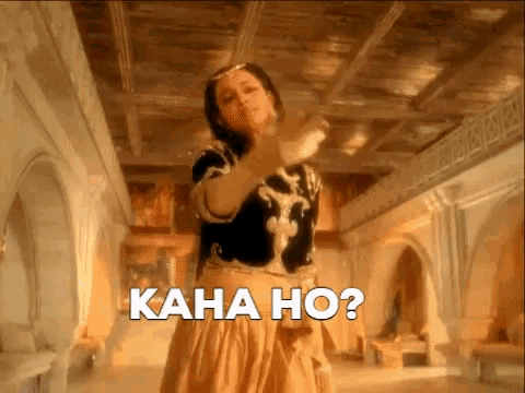 a woman is dancing in a room with the words kaha ho written on the screen .