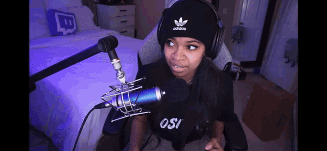 a girl wearing headphones and an adidas beanie