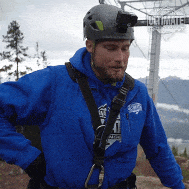 a man in a blue ultimate challenge jacket