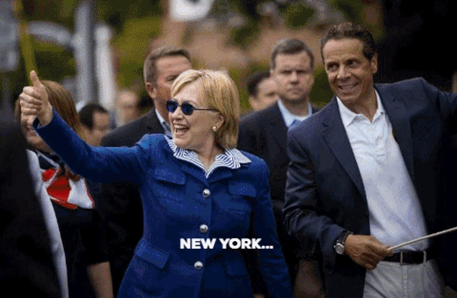 a woman in a blue jacket giving a thumbs up with the words new york below her