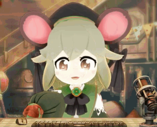 a cartoon character with green hair and pink ears is sitting at a desk