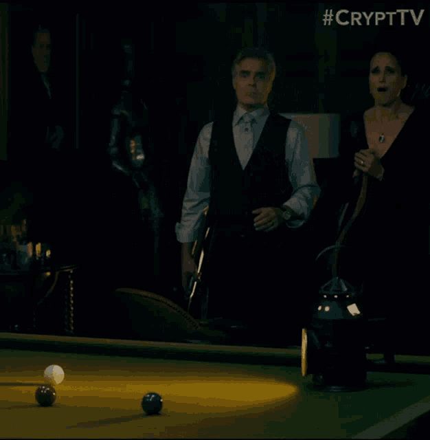 a man covering his mouth while playing pool with #crypttv written on the bottom