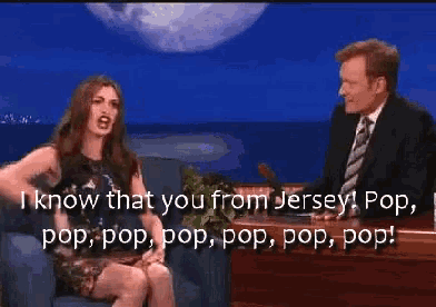 a man and a woman are sitting in front of a screen that says i know that you from jersey pop