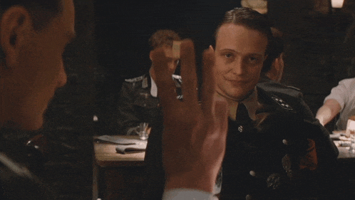 a man in a military uniform holds up his finger