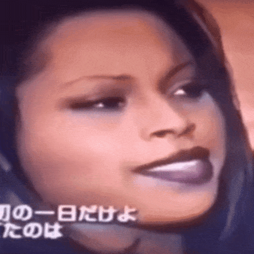 a close up of a woman 's face with foreign writing in the corner