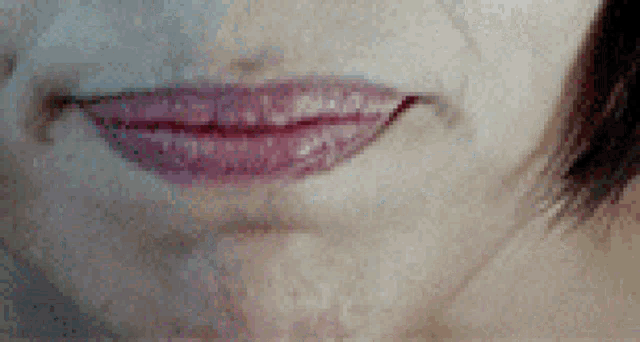 a close up of a woman 's mouth with red lipstick on
