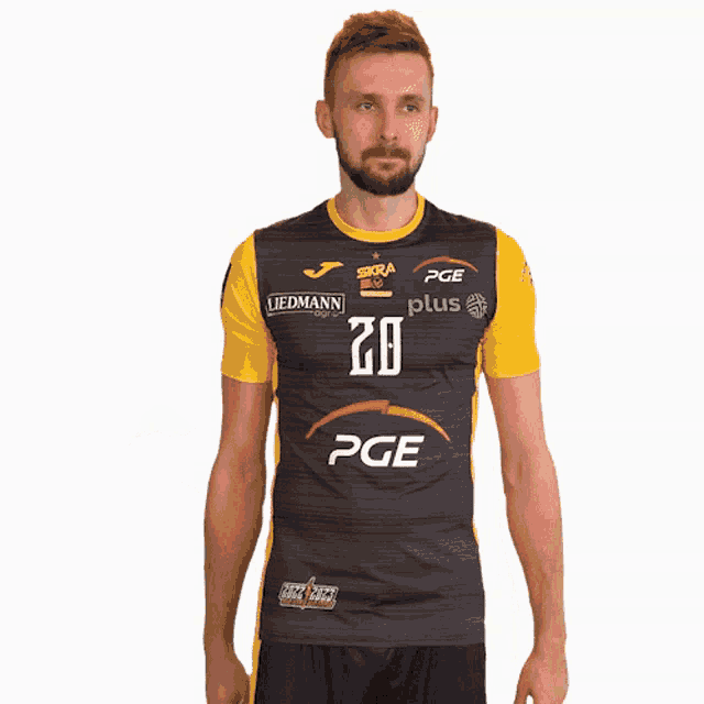 a man wearing a black and yellow shirt with the number 20