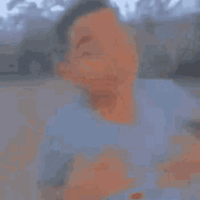 a blurry picture of a man standing on a beach .