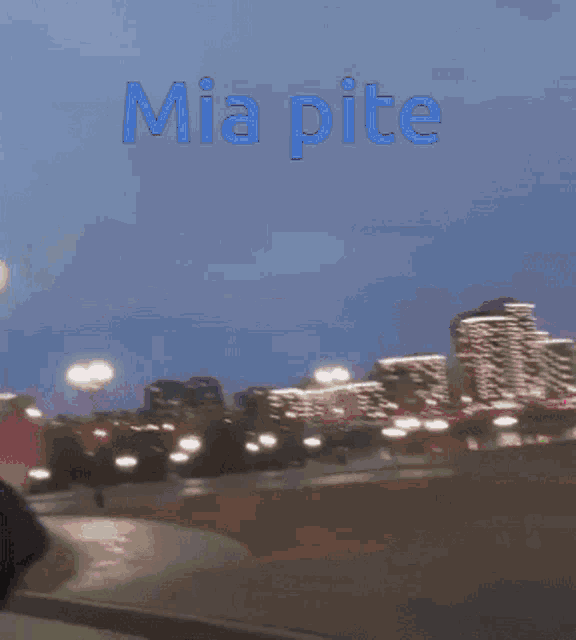 a blurry picture of a city with the words mia pite written on the top
