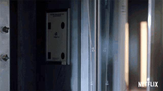 a netflix logo can be seen on the bottom of a door