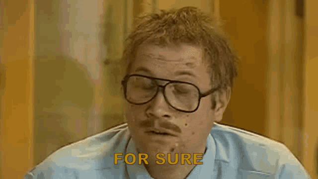 a man with glasses and a mustache says `` for sure '' while smoking a cigarette .