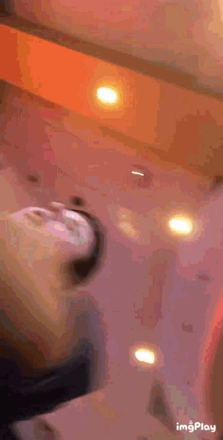 a blurry picture of a person laying on a bed with the words imgplay on the bottom