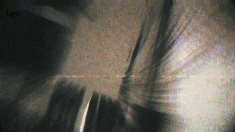 a blurred image of a person 's face with the word lugy visible in the corner