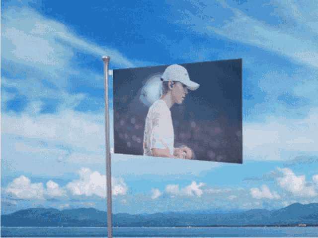 a flag with a picture of a man in a white hat on it
