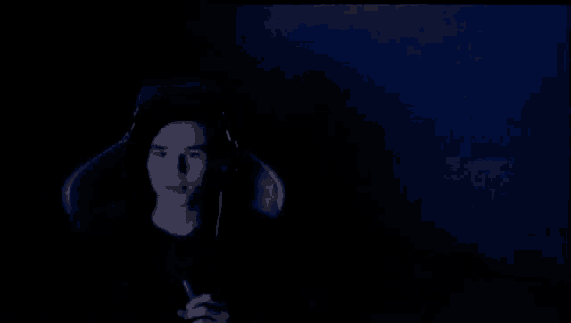 a dark room with a blue light coming from the ceiling