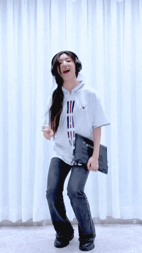 a girl wearing headphones and a white shirt with a flag on it