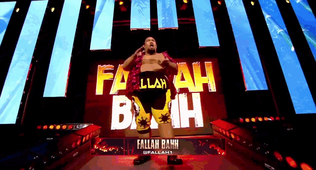 a wrestler named fallah bahh is standing on stage