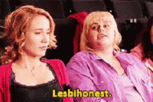 two women are sitting next to each other in a theater and one of them is saying lesbianest