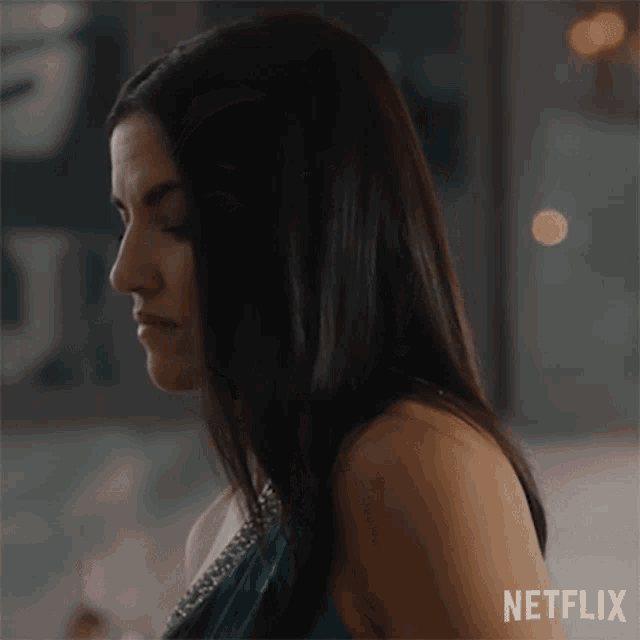 a woman in a blue dress is shown in a netflix advertisement