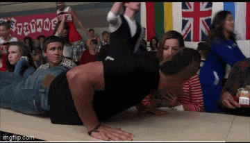 a man is doing push ups in front of a sign that says ' titans '