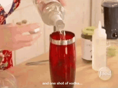 someone is pouring a shot of vodka into a glass