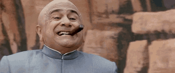 a bald man is smoking a cigar in front of a wall