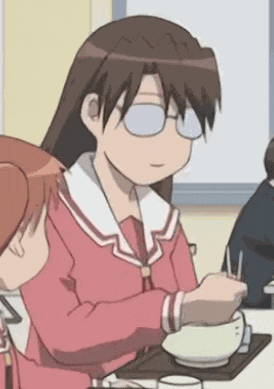 a girl wearing glasses is sitting at a table with a bowl of food and chopsticks .