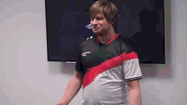 a man wearing a black and red shirt with the letters ecg on it