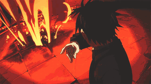 a man stands in front of a fire with his hand pointing at it
