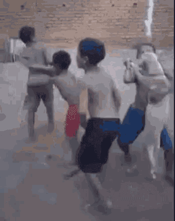 a group of young boys are playing in a pool of water .