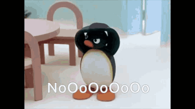 a penguin is standing in front of a table and chairs with the words nooo on the bottom right