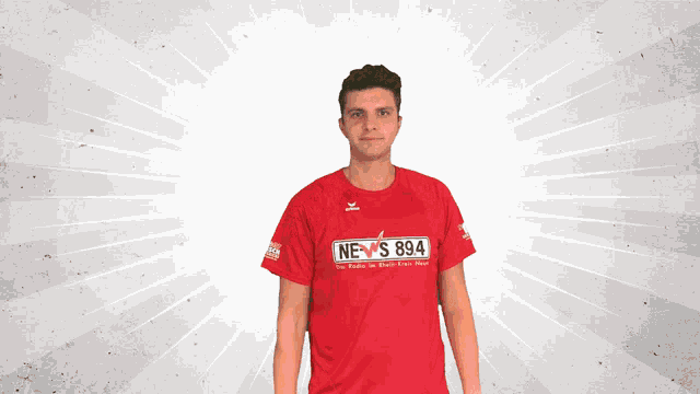 a man wearing a red shirt that says ne s 894 on it