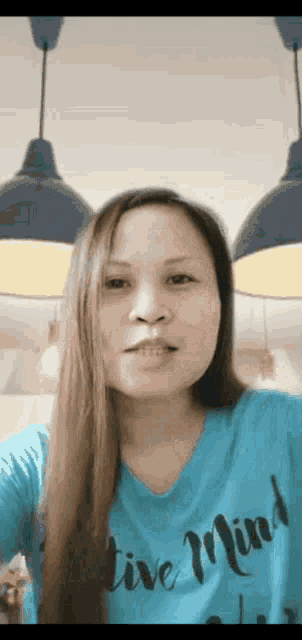 a woman wearing a blue shirt that says active minds on it