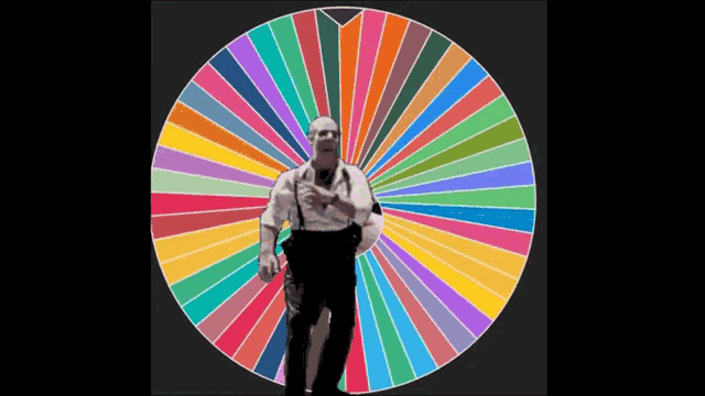 a man stands in front of a colorful circle