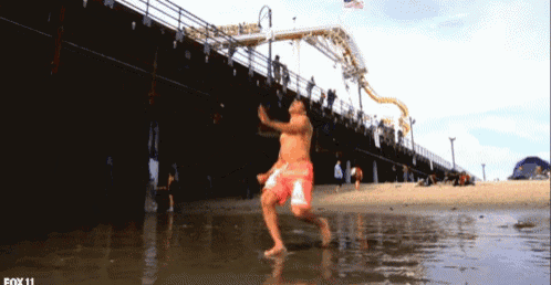 a man is jumping into a body of water with fox 11 written on the bottom