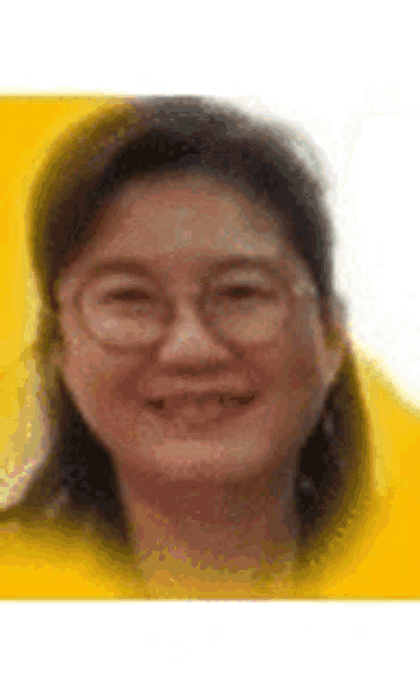a woman wearing glasses is smiling for the camera .