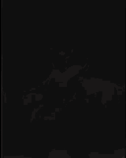 a person is dancing in front of a fire in the dark .