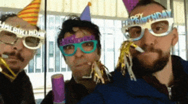 three men wearing party hats and glasses with happy birthday on them