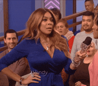 a woman in a blue dress with the word wendy on the waist