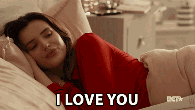 a woman laying in bed with the words i love you written on the bottom