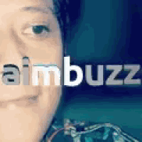 a close up of a person 's face with the word aimbuzz on it .