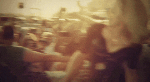 a blurry picture of a crowd of people standing around