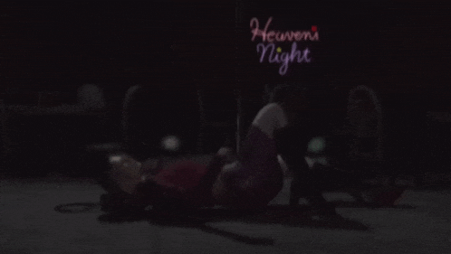 a person is laying on the floor in front of a sign that says heaven 's night