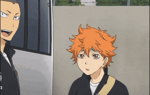 a boy with orange hair stands next to another boy with black hair