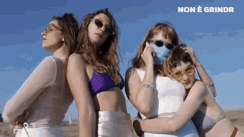a group of women wearing bikinis and sunglasses are standing next to each other with the words non e grindr written above them