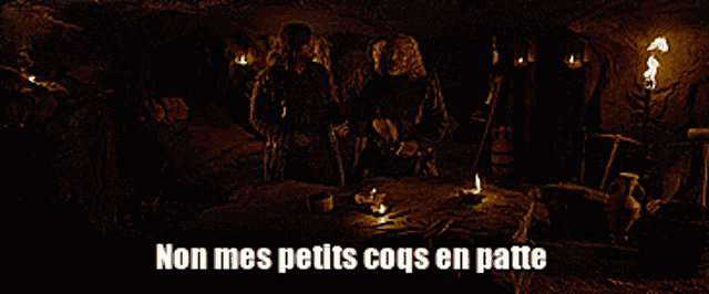 two men are standing in a dark room with the words non mes petits coqs en patte