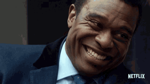 a close up of a man 's face with a netflix logo behind him
