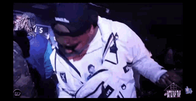 a man wearing a white shirt that says ' life ' on it