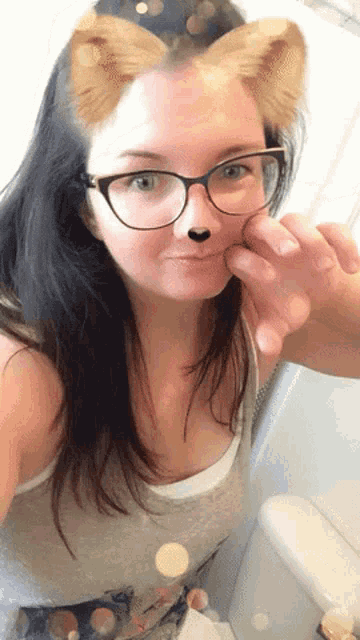 a woman wearing glasses and a cat face mask